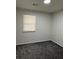 Simple bedroom with gray carpet and window at 4906 Holbrook Cir, Duluth, GA 30096