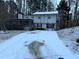 Two-story house covered in snow with a porch and driveway at 4906 Holbrook Cir, Duluth, GA 30096