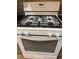 White gas range with four burners and a large oven at 4906 Holbrook Cir, Duluth, GA 30096