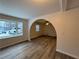 Spacious living room with vinyl flooring, bay window, and arched doorway at 4906 Holbrook Cir, Duluth, GA 30096