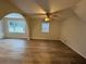 Spacious living room featuring hardwood floors, a large window, and a ceiling fan at 4906 Holbrook Cir, Duluth, GA 30096