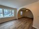 Spacious living room with vinyl flooring, bay window, and arched doorway at 4906 Holbrook Cir, Duluth, GA 30096