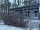 Covered porch with lattice details and wooden railings, snow covered at 4906 Holbrook Cir, Duluth, GA 30096