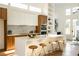 Modern kitchen with white and wood cabinets, marble backsplash, and large island at 2107 Abner Nw Pl, Atlanta, GA 30318