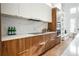 Modern kitchen with wood cabinets, marble backsplash, and gold hardware at 2107 Abner Nw Pl, Atlanta, GA 30318