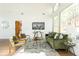 Spacious living room with green velvet sofa and large windows at 2107 Abner Nw Pl, Atlanta, GA 30318
