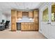 Basement bar with wooden cabinets and sink at 25 Highlands Way, Oxford, GA 30054