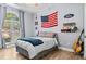 Patriotic themed bedroom with American flag decor and wood floors at 25 Highlands Way, Oxford, GA 30054
