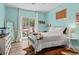 Light teal bedroom with a cowhide rug and wood floors at 25 Highlands Way, Oxford, GA 30054
