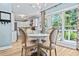 Bright dining area with a table for four and view of the kitchen at 25 Highlands Way, Oxford, GA 30054