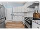 Modern kitchen with white cabinets, granite countertops, and stainless steel appliances at 25 Highlands Way, Oxford, GA 30054