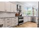 Modern kitchen with white cabinets, granite countertops, and stainless steel appliances at 25 Highlands Way, Oxford, GA 30054
