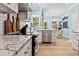 Modern kitchen with white cabinets, granite countertops, and stainless steel appliances at 25 Highlands Way, Oxford, GA 30054