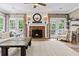Living room with a brick fireplace and comfortable seating at 25 Highlands Way, Oxford, GA 30054