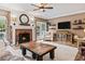 Living room with a brick fireplace and built-in shelving at 25 Highlands Way, Oxford, GA 30054