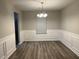 Dining room with neutral walls, wood floors, and chair railing at 5863 Seabright Ln, Atlanta, GA 30349