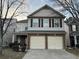 Two-story house with a double-car garage and neutral siding at 5863 Seabright Ln, Atlanta, GA 30349