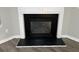 Modern fireplace with black surround and gray stone hearth at 5863 Seabright Ln, Atlanta, GA 30349