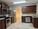 Modern kitchen with stainless steel appliances and dark wood cabinets at 5863 Seabright Ln, Atlanta, GA 30349