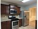Stainless steel appliances and dark wood cabinets in this modern kitchen at 5863 Seabright Ln, Atlanta, GA 30349