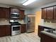 Modern kitchen with stainless steel appliances and dark wood cabinets at 5863 Seabright Ln, Atlanta, GA 30349