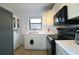 Efficient kitchen with white cabinets, black appliances, and ample counter space at 692 Argonne Ne Ave # 2, Atlanta, GA 30308