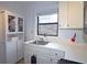 White kitchen cabinets, black appliances, and a window overlooking the backyard at 692 Argonne Ne Ave # 2, Atlanta, GA 30308