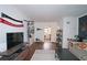 Living room with hardwood floors, TV, and view into the kitchen at 692 Argonne Ne Ave # 2, Atlanta, GA 30308