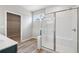 Bathroom featuring a glass-enclosed shower and a view into the walk-in closet at 14 Cambridge Ln, Dallas, GA 30157