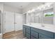 Bathroom with double sink vanity, large mirror, modern lighting, and walk-in shower at 14 Cambridge Ln, Dallas, GA 30157