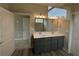 Bathroom featuring a double vanity, large mirror, and modern lighting fixtures at 14 Cambridge Ln, Dallas, GA 30157