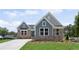 Charming single-Gathering home featuring stone accents, manicured lawn, and a private driveway under a bright blue sky at 14 Cambridge Ln, Dallas, GA 30157