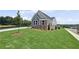 Attractive single-Gathering home with well-manicured lawn, stone accents, grey siding, and professional landscaping at 14 Cambridge Ln, Dallas, GA 30157