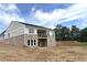View of home's exterior featuring stone accents, siding, and a deck, all under a blue sky at 14 Cambridge Ln, Dallas, GA 30157