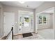 Inviting foyer showcasing a modern front door with sidelights and transom window, and a view into a carpeted living space at 14 Cambridge Ln, Dallas, GA 30157