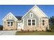 Charming new construction home with a stone and siding exterior and manicured lawn at 14 Cambridge Ln, Dallas, GA 30157