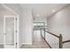 Bright hallway with hardwood floors and white trim, leading to a living area with natural light streaming through the windows at 14 Cambridge Ln, Dallas, GA 30157