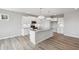 Modern kitchen with white cabinets, stainless steel appliances, island with sink, and hardwood floors, ideal for cooking and entertaining at 14 Cambridge Ln, Dallas, GA 30157