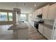 Bright kitchen featuring a large island, white cabinetry, and stainless steel appliances at 14 Cambridge Ln, Dallas, GA 30157