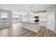 Bright kitchen features an island with sink, stainless steel appliances, and stylish pendant lighting at 14 Cambridge Ln, Dallas, GA 30157