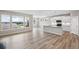 Open-concept kitchen with white cabinets, stainless steel appliances, an island, and hardwood flooring, ideal for cooking and socializing at 14 Cambridge Ln, Dallas, GA 30157