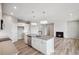 Open-concept living space with a modern kitchen island, fireplace, and sleek, recessed lighting at 14 Cambridge Ln, Dallas, GA 30157