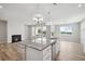 Inviting open space featuring a modern fireplace, a kitchen island, and bright natural light from the many windows at 14 Cambridge Ln, Dallas, GA 30157