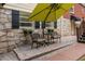 Stone patio with umbrella, table, chairs, perfect for outdoor relaxation at 1417 Sheridan Ne Rd, Atlanta, GA 30324