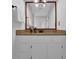 Updated bathroom with a white vanity, granite countertop, and framed mirror at 2700 Pine Tree Ne Rd # 2306, Atlanta, GA 30324