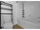 Well-lit bathroom featuring a combined tub and shower, modern toilet, and storage at 2700 Pine Tree Ne Rd # 2306, Atlanta, GA 30324