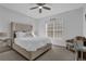Bright bedroom with a large bed, mirrored nightstand, and a ceiling fan at 2700 Pine Tree Ne Rd # 2306, Atlanta, GA 30324