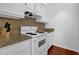 Kitchen with white cabinets and appliances, granite countertops, and backsplash at 2700 Pine Tree Ne Rd # 2306, Atlanta, GA 30324