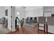 A modern living room with hardwood floors, gray sofa, and kitchen barstools at 2700 Pine Tree Ne Rd # 2306, Atlanta, GA 30324