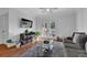 Bright living room with hardwood floors, ceiling fan, and doors leading to a balcony or patio at 2700 Pine Tree Ne Rd # 2306, Atlanta, GA 30324